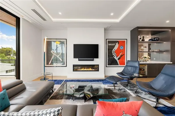 a living room with furniture workspace and a flat screen tv