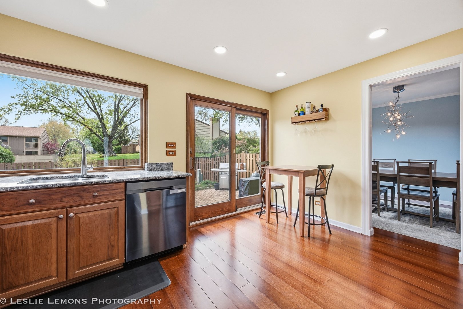 497 Sequoia Trail Roselle, IL 60172 - Photo 11 of 21 a open kitchen with granite countertop a stove dining table chairs and wooden floor