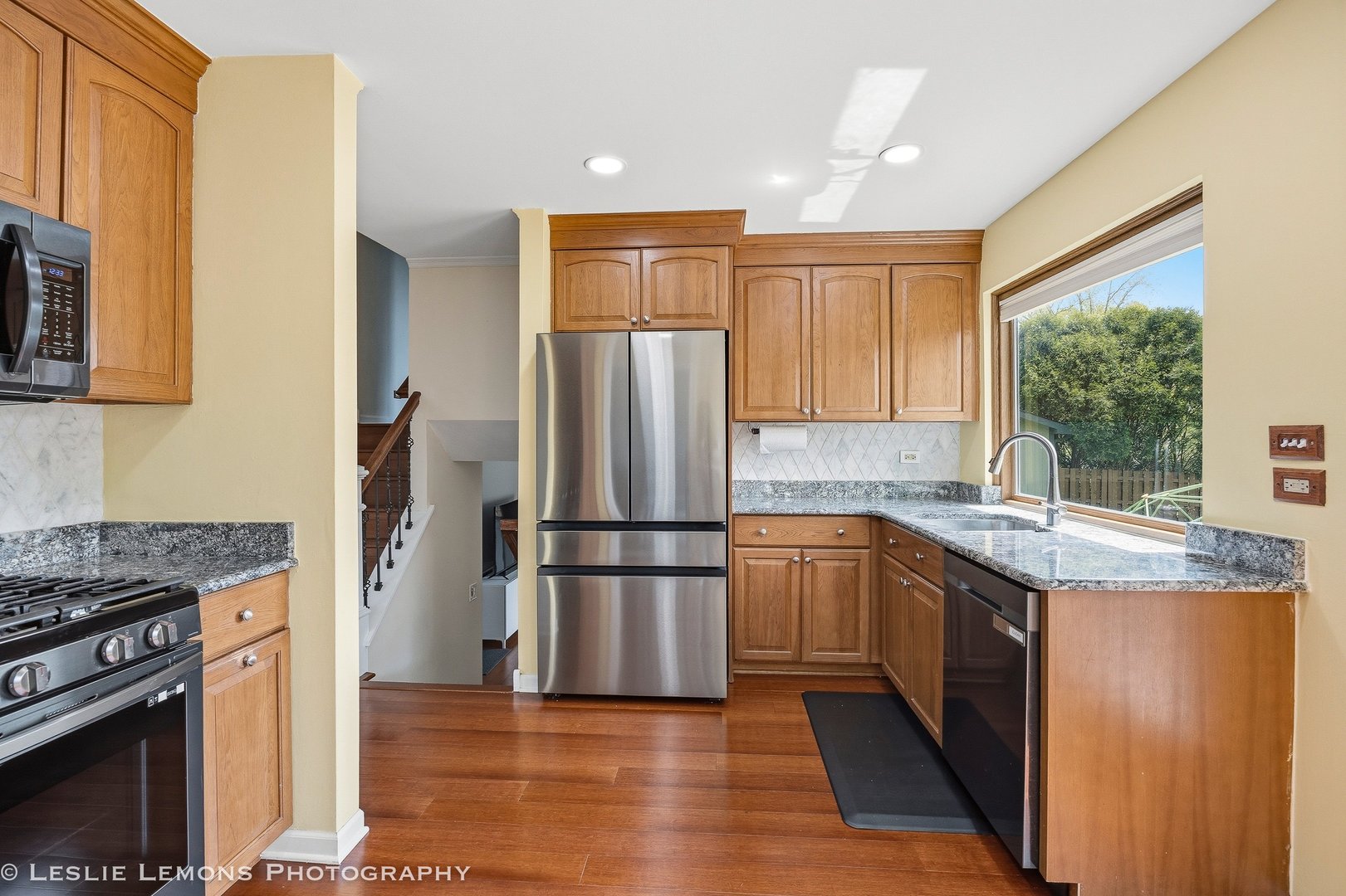 497 Sequoia Trail Roselle, IL 60172 - Photo 9 of 21 a kitchen with stainless steel appliances granite countertop a refrigerator a stove a sink and a microwave