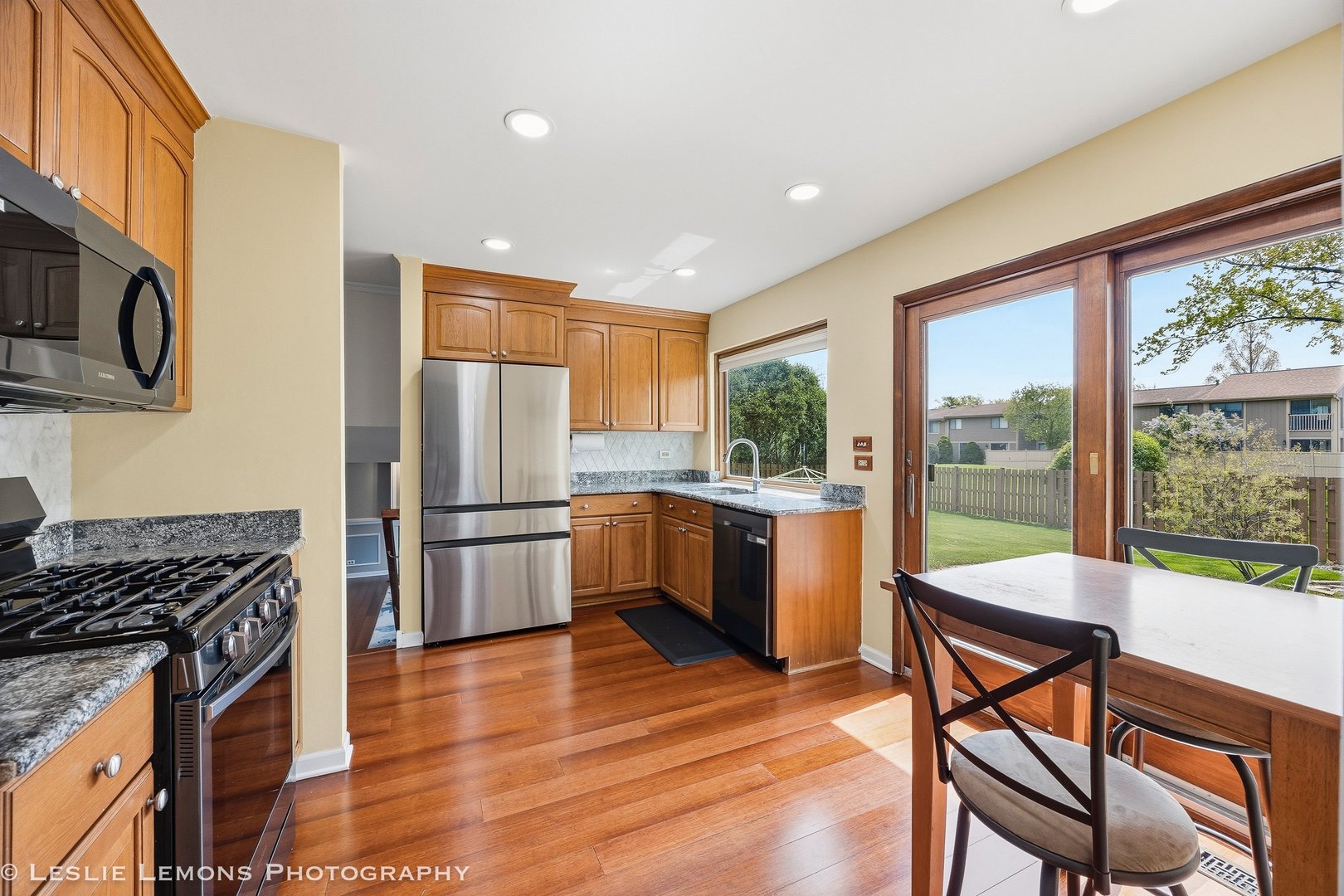 497 Sequoia Trail Roselle, IL 60172 - Photo 10 of 21 a kitchen with a stove a refrigerator and wooden floor