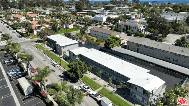 an aerial view of a residential houses with outdoor space