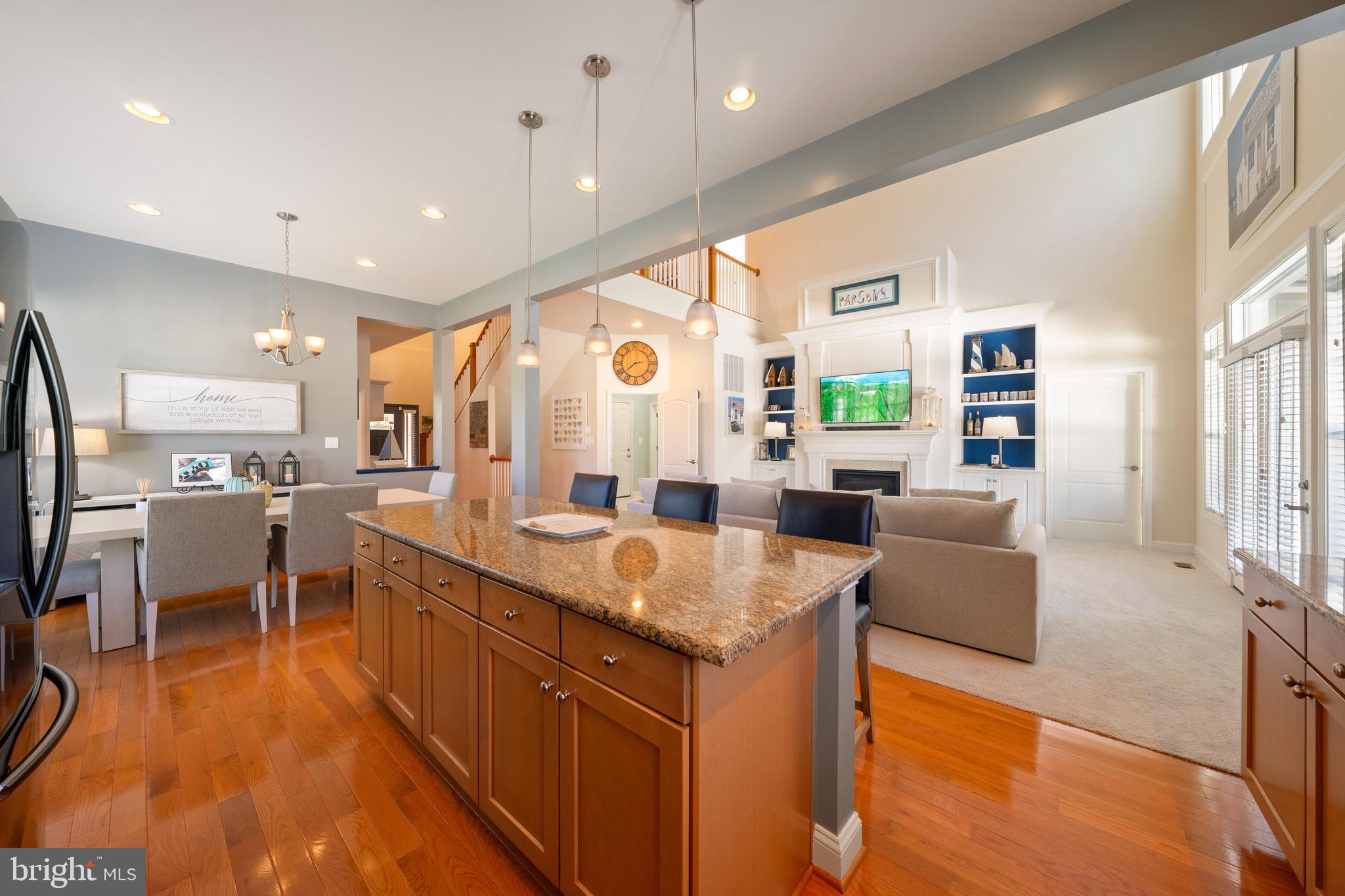 400 Shipyard Way Solomons, MD 20688 - Photo 11 of 100 a large living room with stainless steel appliances granite countertop couches a fireplace and a large window