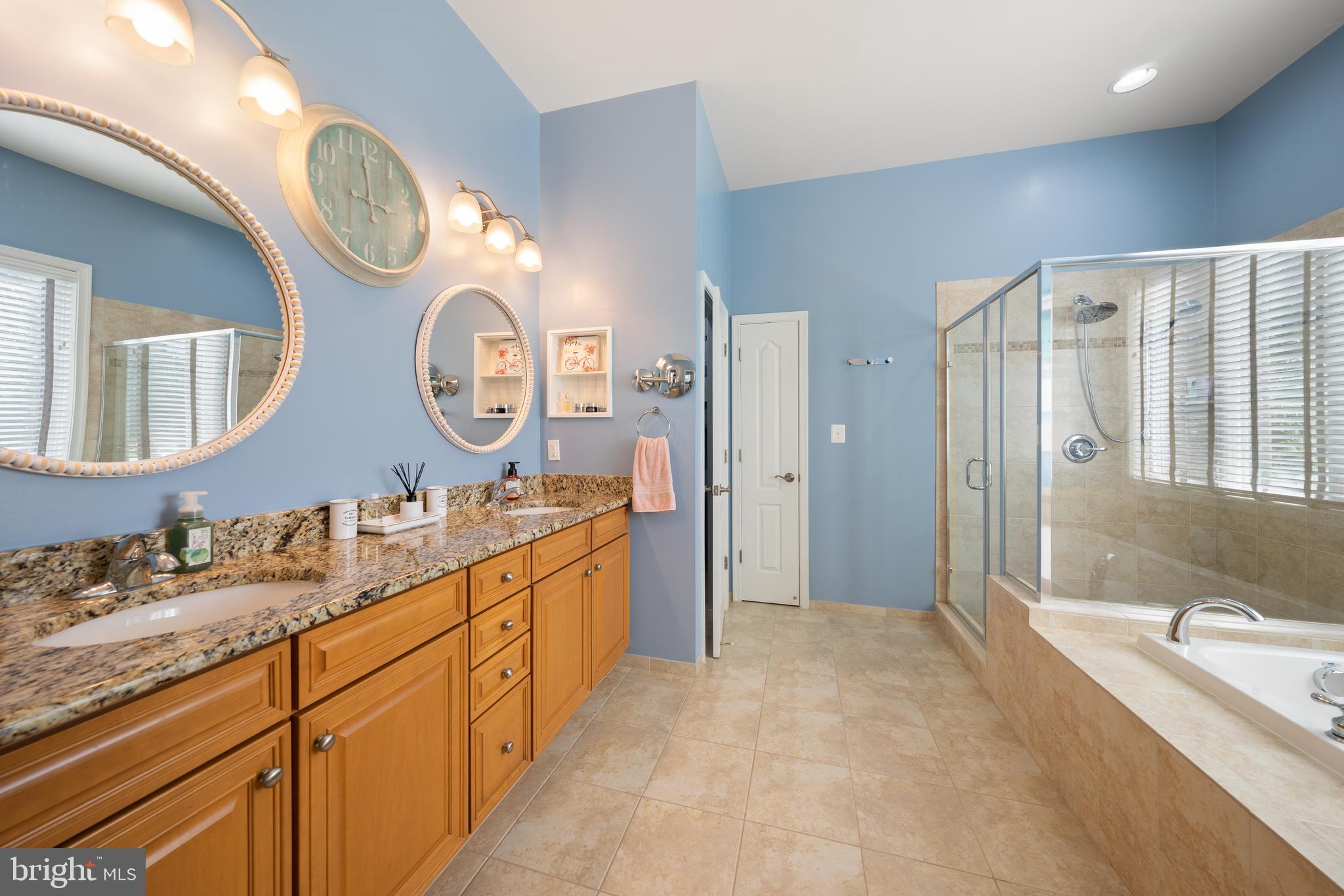 400 Shipyard Way Solomons, MD 20688 - Photo 18 of 100 a spacious bathroom with a granite countertop double vanity sink and a mirror