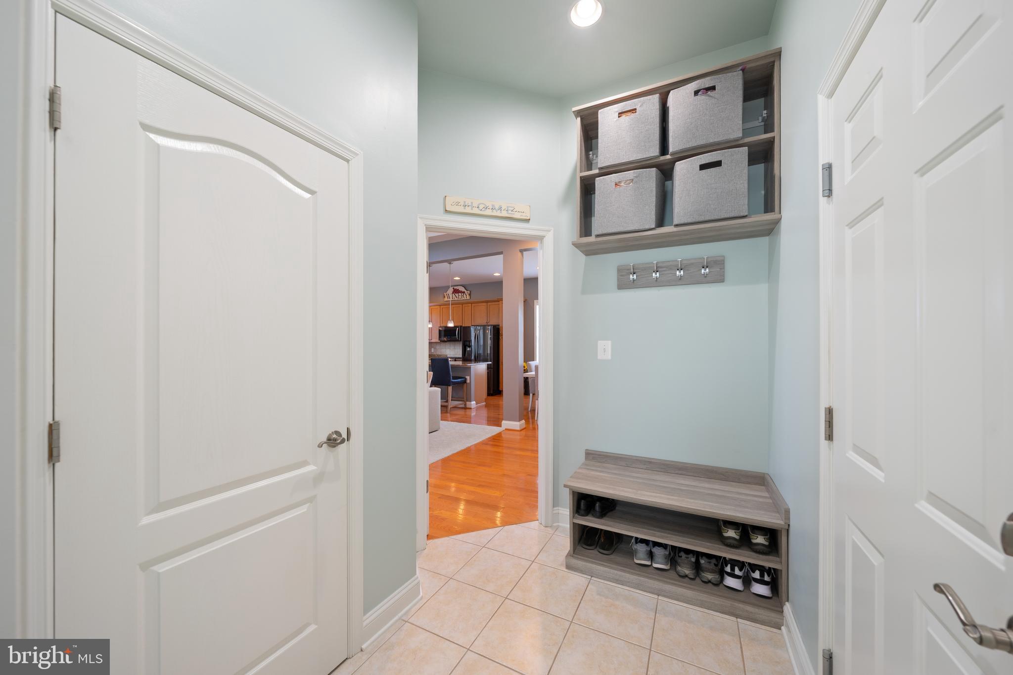 400 Shipyard Way Solomons, MD 20688 - Photo 25 of 100 a kitchen with white cabinets and a refrigerator