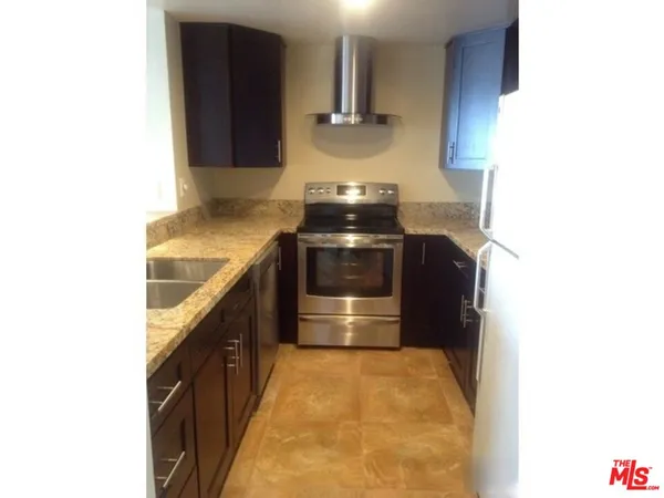 a kitchen with a sink and a stove