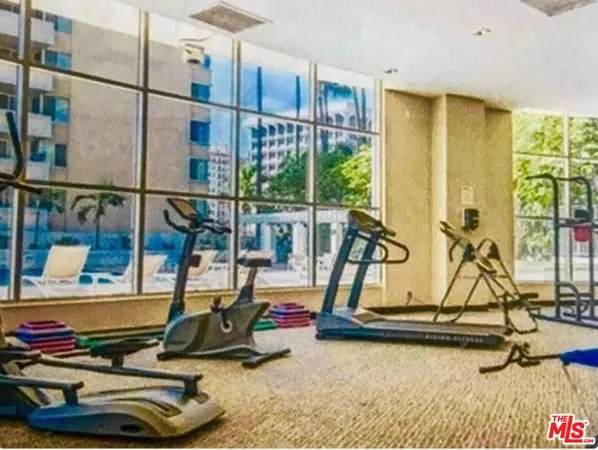 a room with gym equipment and windows