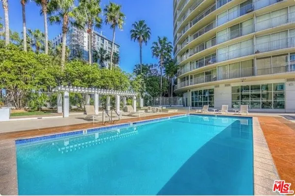 a view of pool with outdoor seating and yard