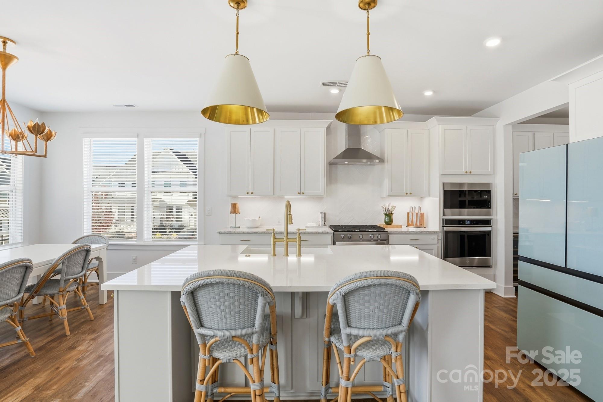 6246 Six String Court Fort Mill, SC 29708 - Photo 2 of 48 a kitchen with stainless steel appliances granite countertop a table chairs and a refrigerator