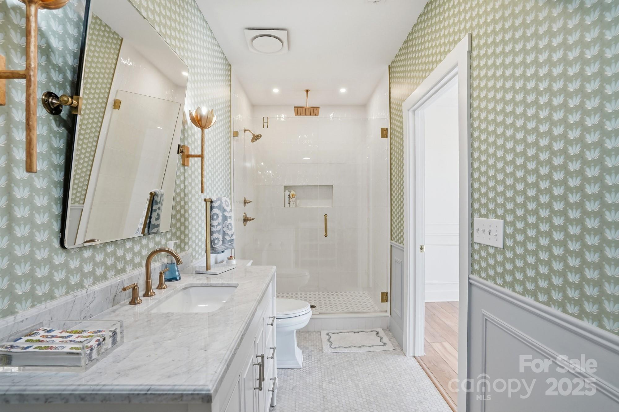 6246 Six String Court Fort Mill, SC 29708 - Photo 21 of 48 a bathroom with a granite countertop sink a toilet and shower
