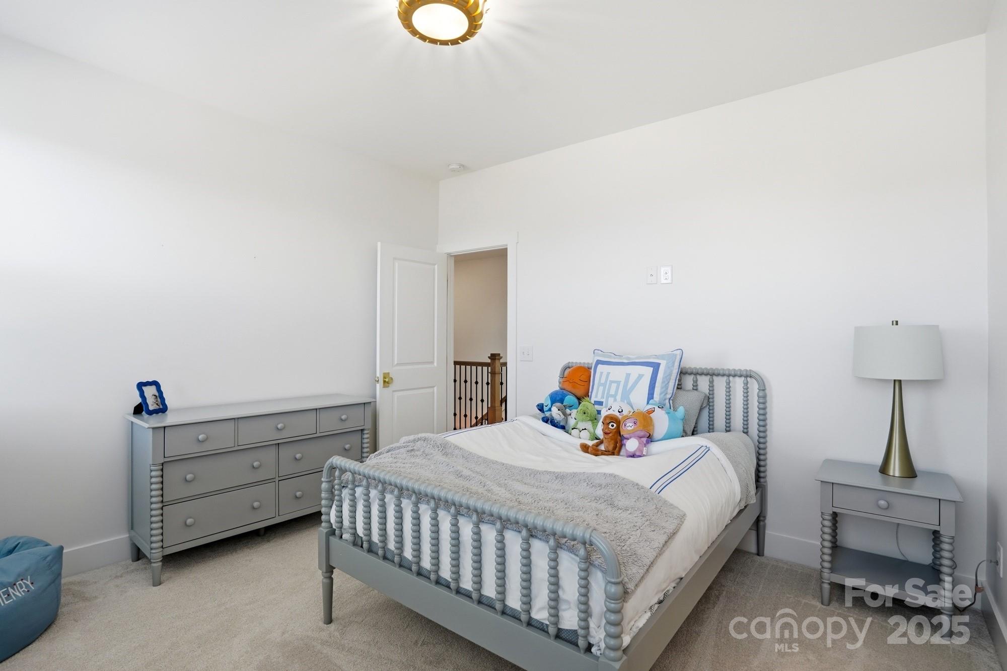 6246 Six String Court Fort Mill, SC 29708 - Photo 24 of 48 a bedroom with a bed and a lamp on the dresser