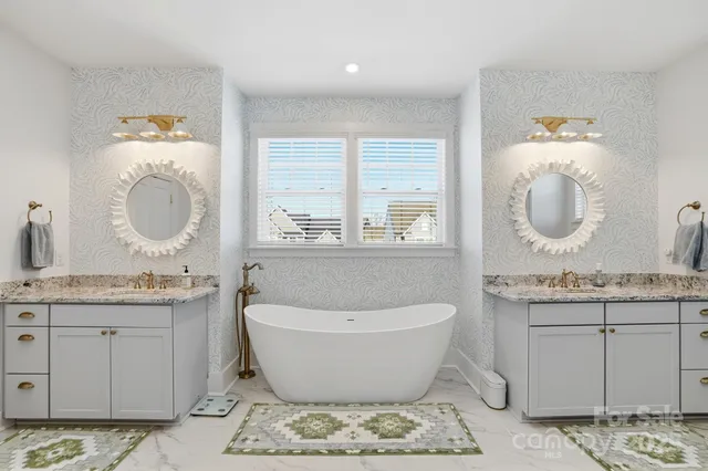 a spacious bathroom with a granite countertop sink and a mirror