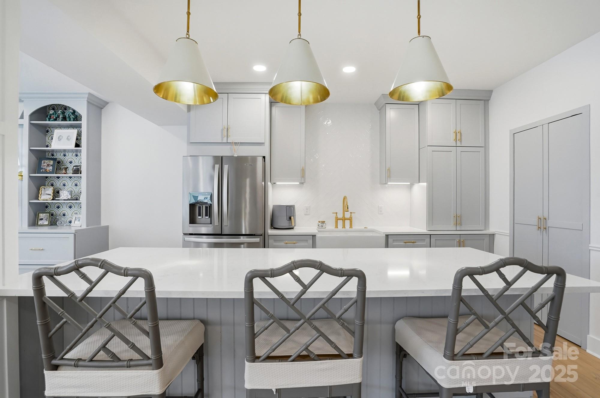 6246 Six String Court Fort Mill, SC 29708 - Photo 8 of 48 a kitchen with stainless steel appliances kitchen island a table and chairs in it
