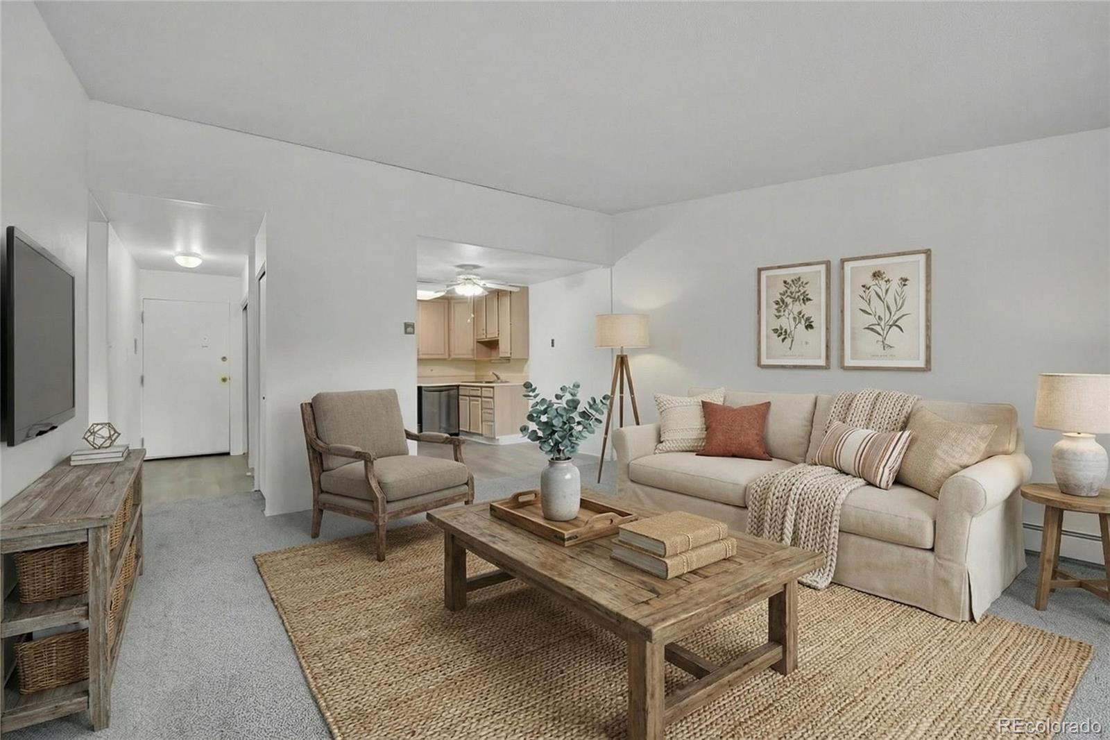 a living room with furniture a rug and a flat screen tv