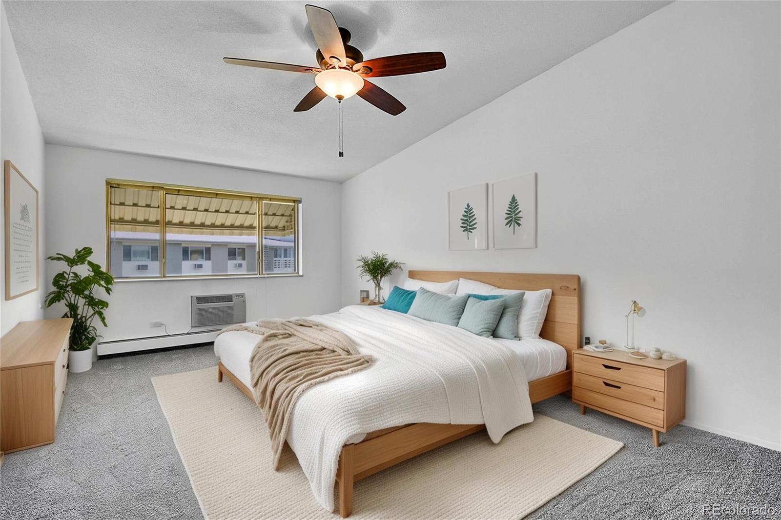 9655 Center Avenue, Unit 9D Denver, CO 80247 - Photo 11 of 21 a bedroom with a bed and a chandelier