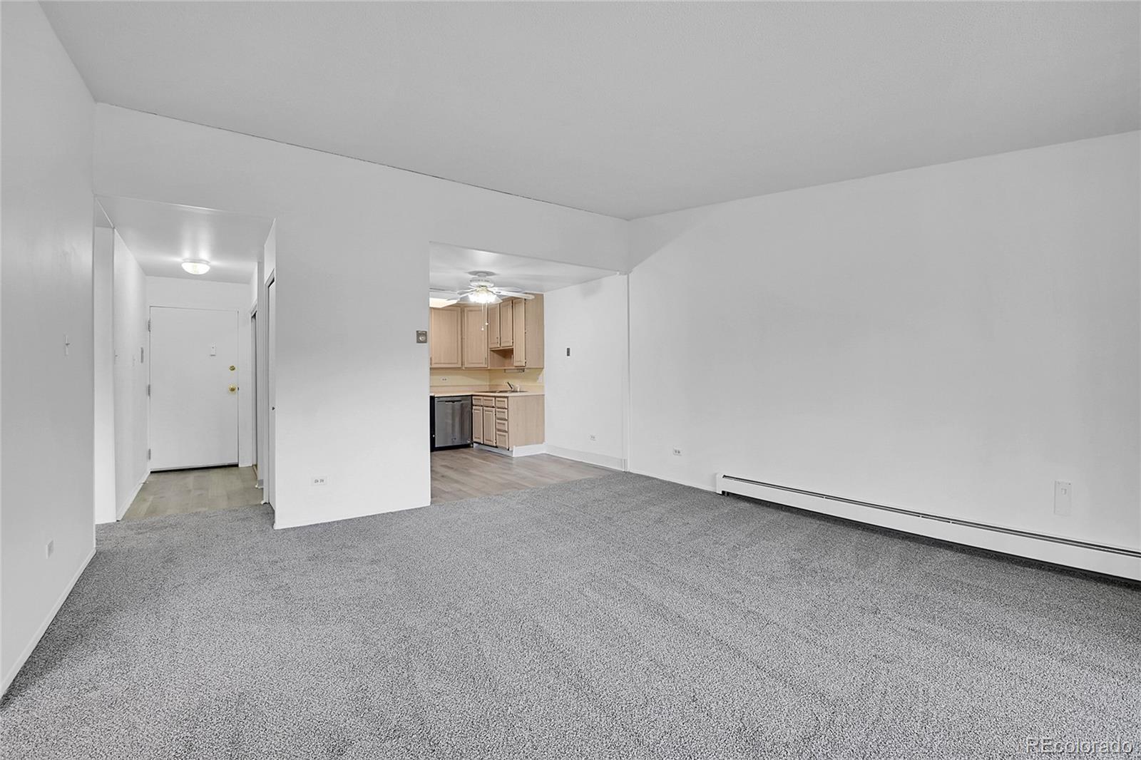 9655 Center Avenue, Unit 9D Denver, CO 80247 - Photo 16 of 21 a view of empty room with a kitchen