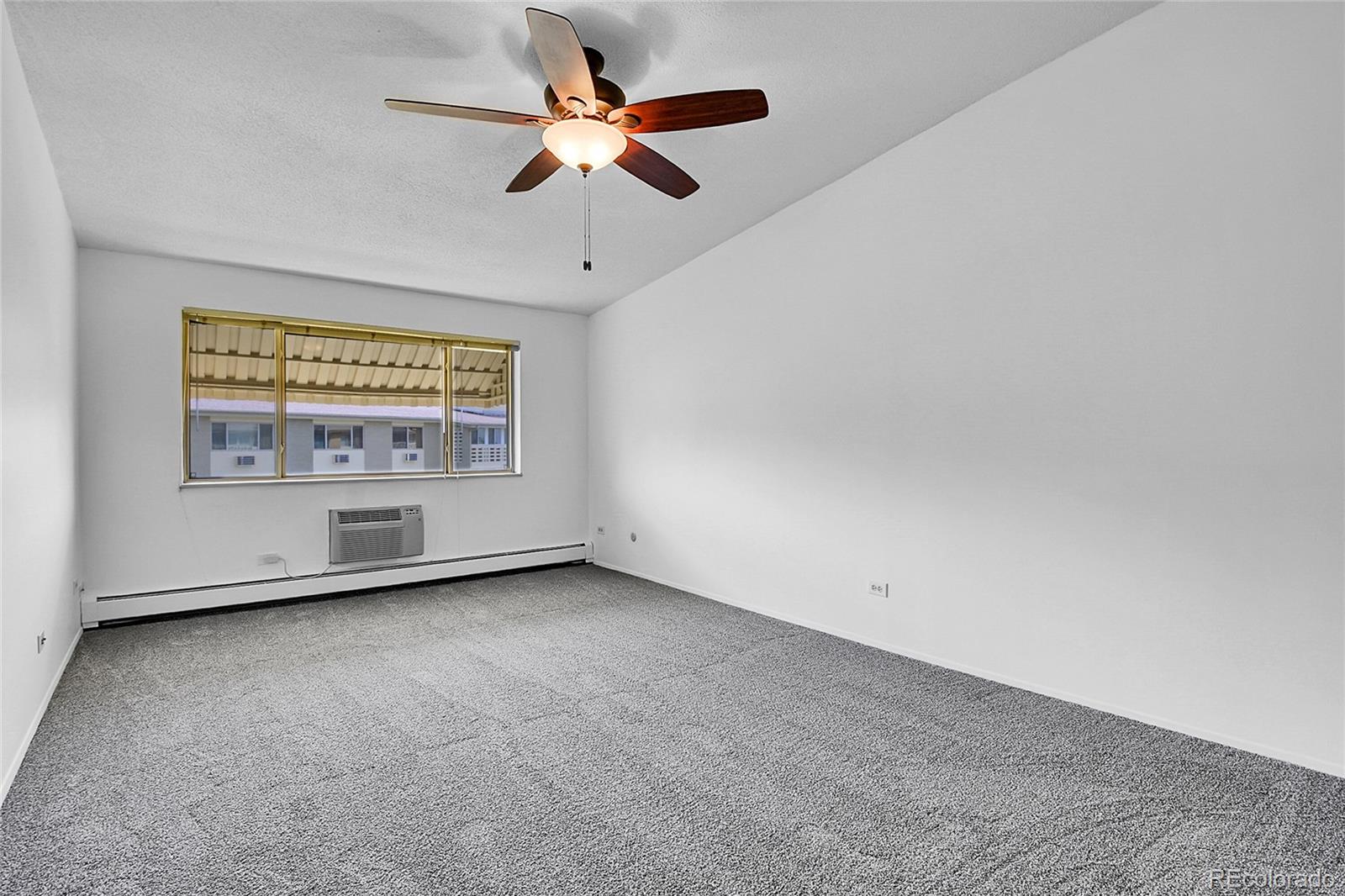 9655 Center Avenue, Unit 9D Denver, CO 80247 - Photo 19 of 21 an empty room with a empty space and a ceiling fan