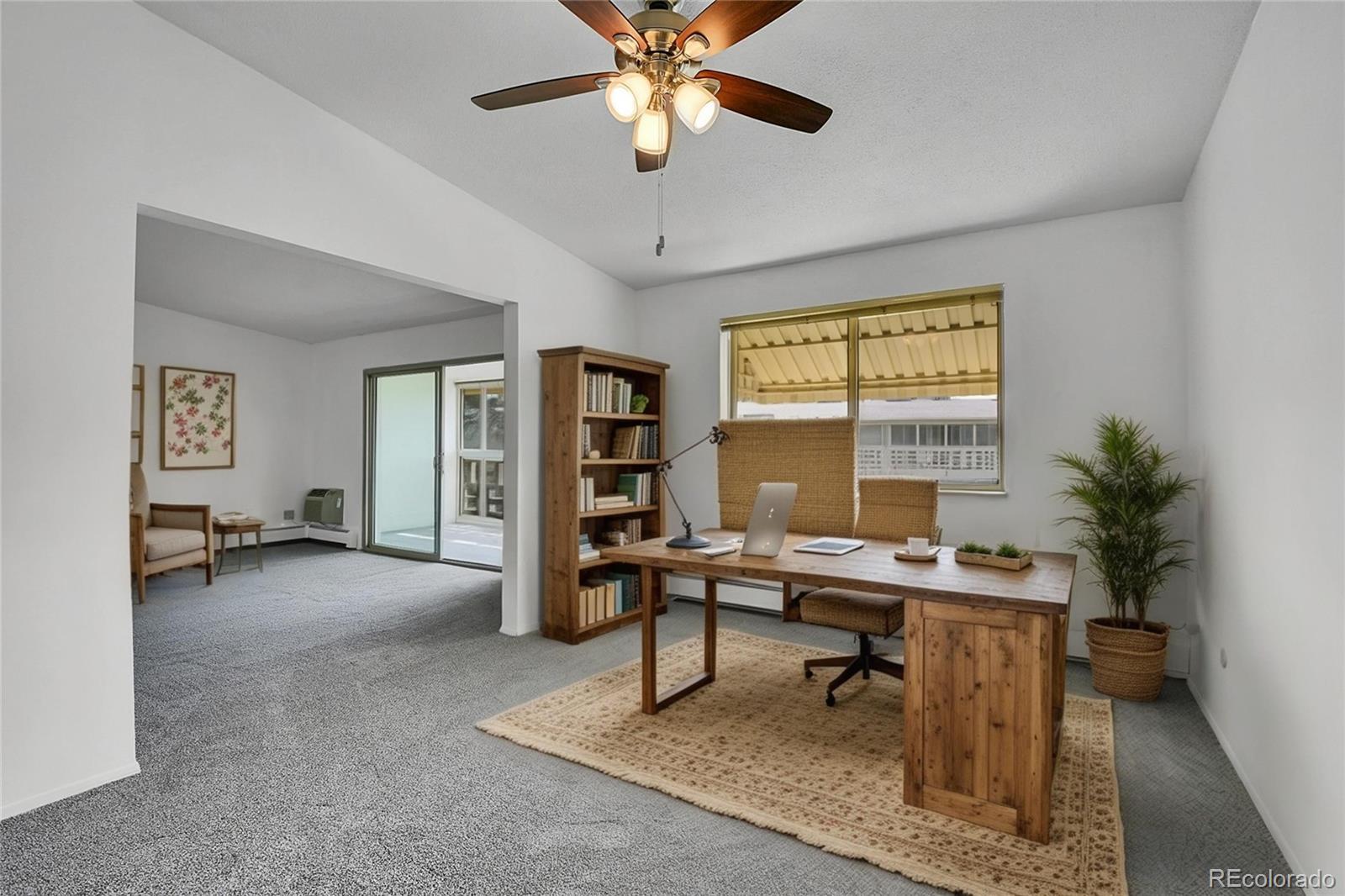 9655 Center Avenue, Unit 9D Denver, CO 80247 - Photo 2 of 21 a view of a livingroom with workspace and a window