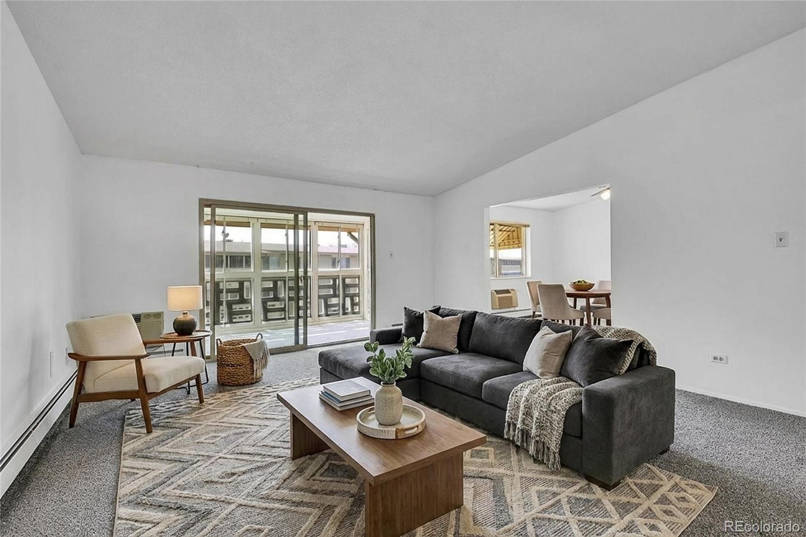 9655 Center Avenue, Unit 9D Denver, CO 80247 - Photo 5 of 21 a living room with furniture and a window