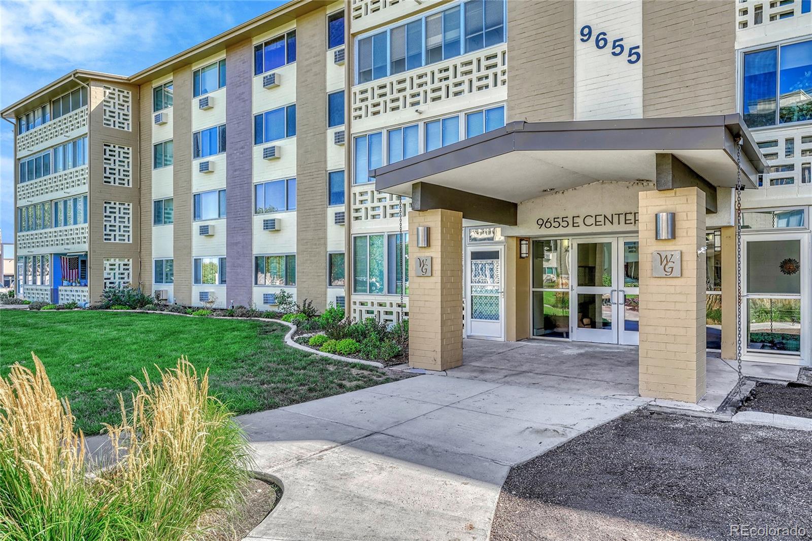 9655 Center Avenue, Unit 9D Denver, CO 80247 - Photo 6 of 21 a view of a building with a yard