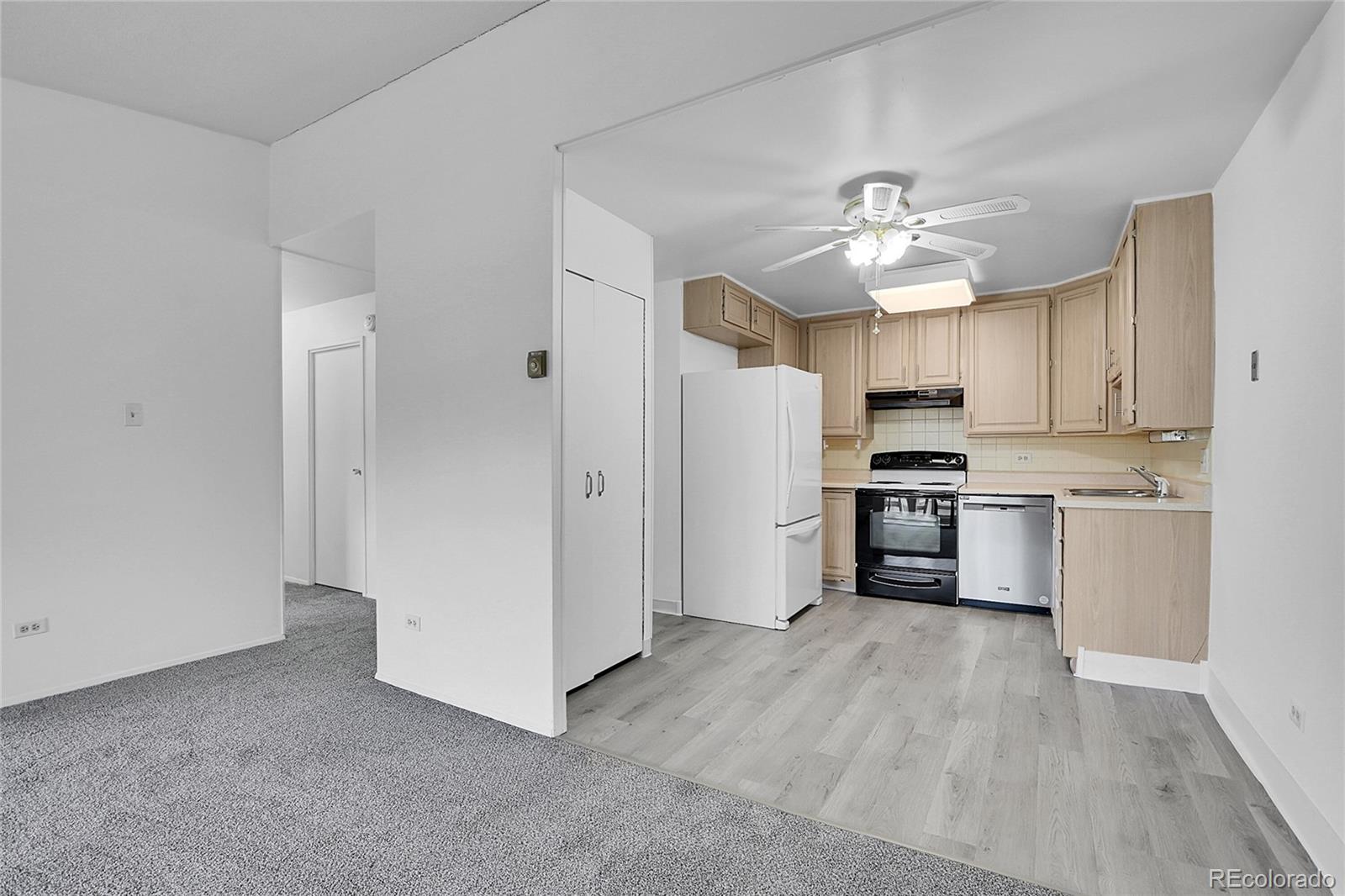 9655 Center Avenue, Unit 9D Denver, CO 80247 - Photo 7 of 21 a kitchen with stainless steel appliances a refrigerator and a stove top oven