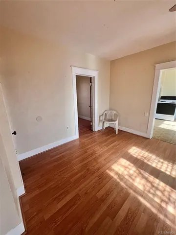 a view of a room with wooden floor and chair