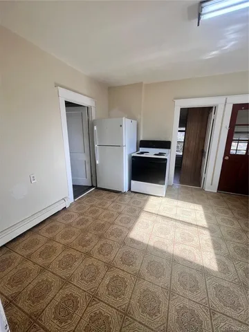 a room with a stove and a refrigerator