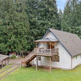 a aerial view of a house with a yard table and chairs