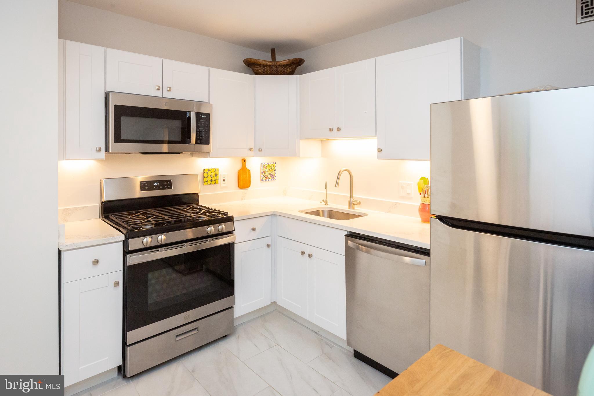 3001 Veazey Terrace Northwest, Unit 1128 Washington, DC 20008 - Photo 2 of 22 a kitchen with a refrigerator sink and microwave