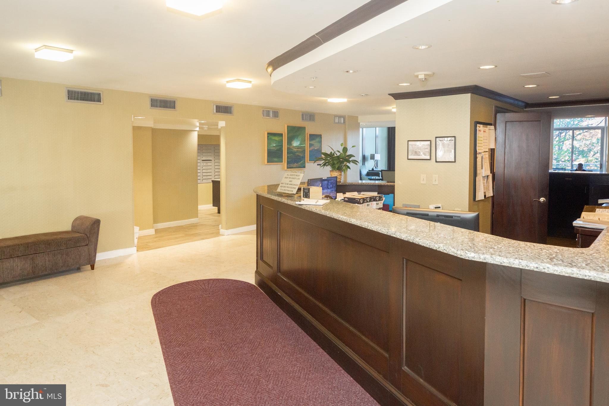 3001 Veazey Terrace Northwest, Unit 1128 Washington, DC 20008 - Photo 21 of 22 a large kitchen with kitchen island a sink stainless steel appliances and cabinets