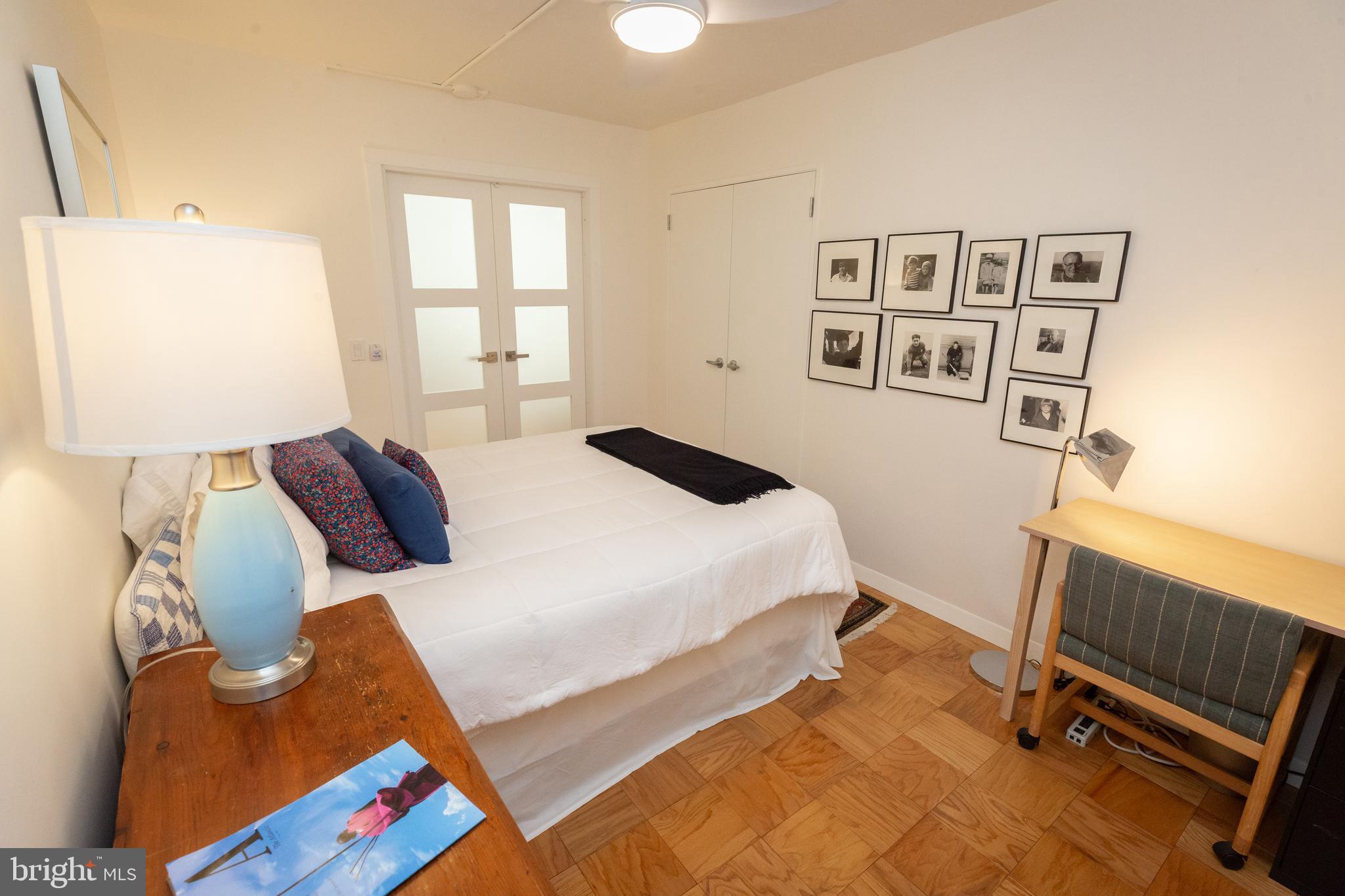 3001 Veazey Terrace Northwest, Unit 1128 Washington, DC 20008 - Photo 4 of 22 a bedroom with a bed and wooden floor