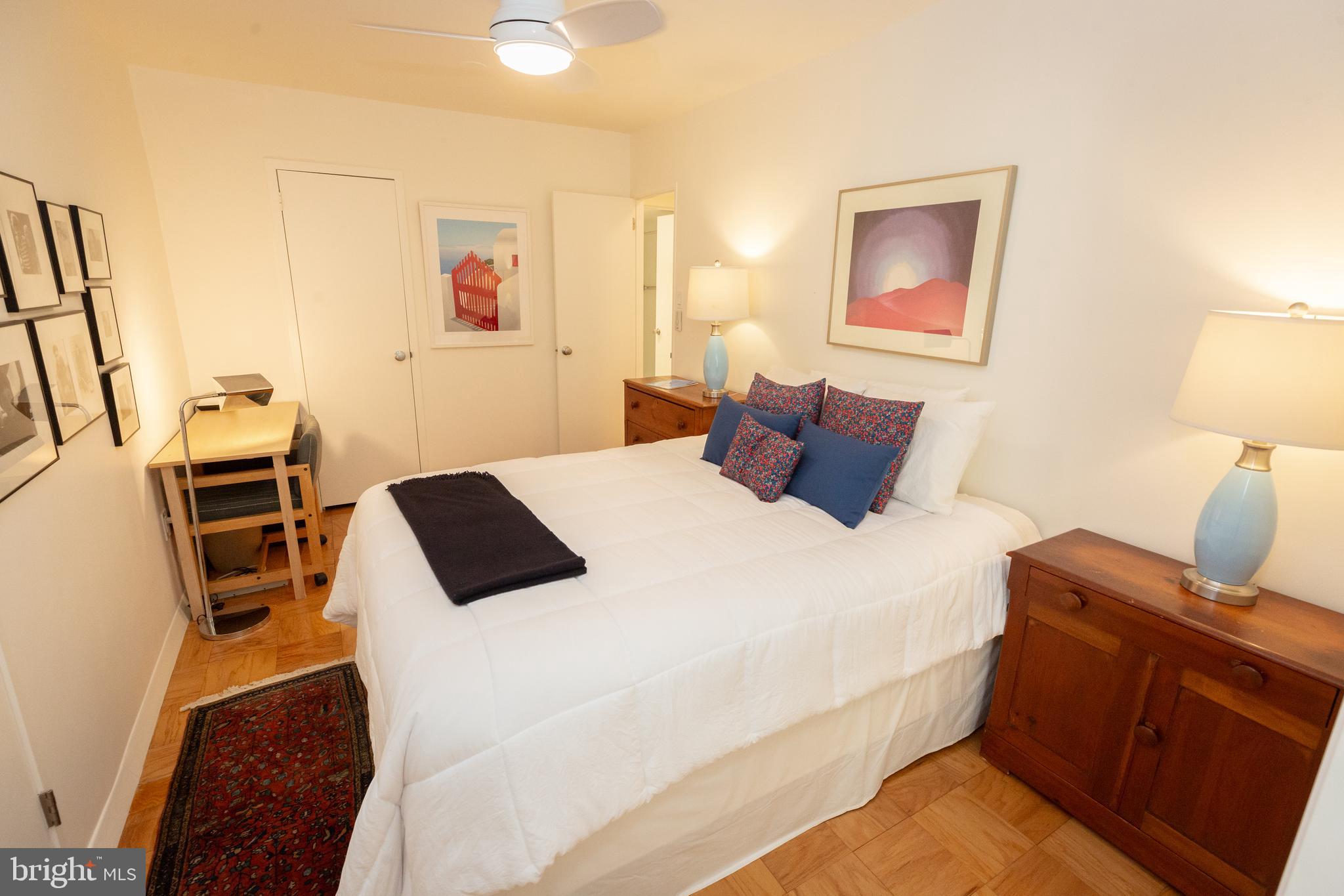 3001 Veazey Terrace Northwest, Unit 1128 Washington, DC 20008 - Photo 5 of 22 a bedroom with a bed and wooden floor