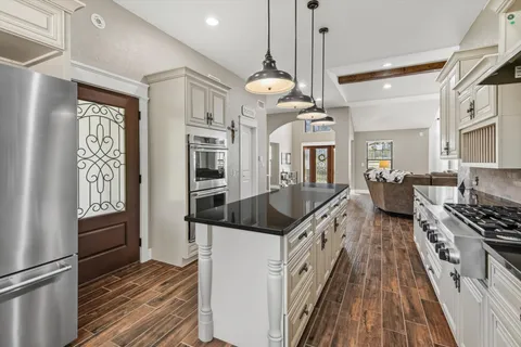 a kitchen with stainless steel appliances granite countertop a stove and a sink