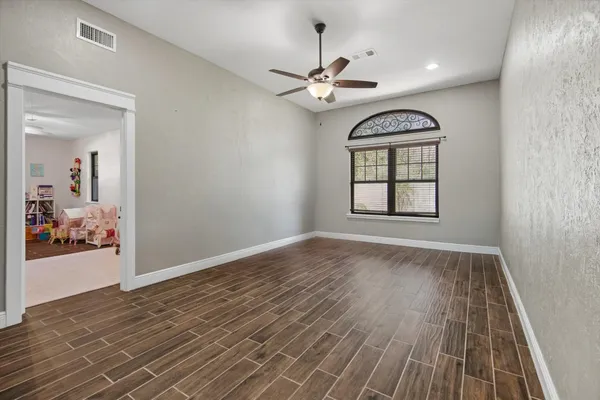 wooden floor in an empty room with a window