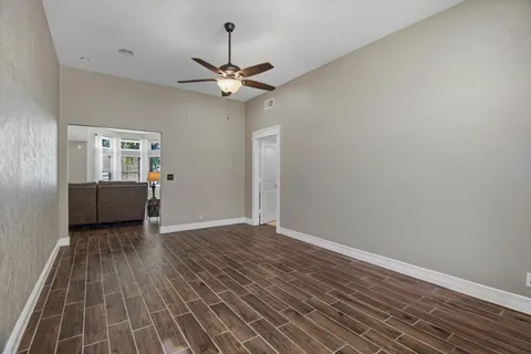 wooden floor in an empty room with a window