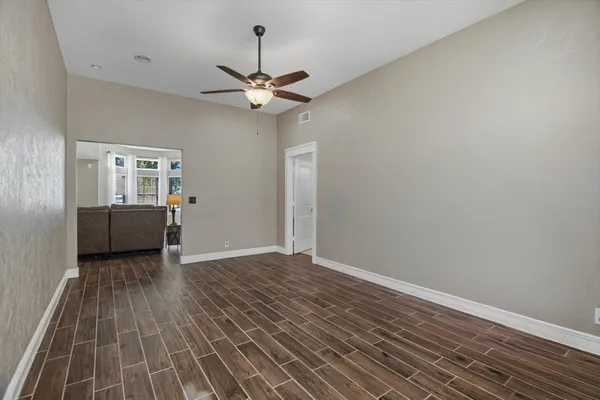 wooden floor in an empty room with a window