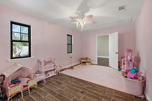 a bedroom with a bed dresser and a window