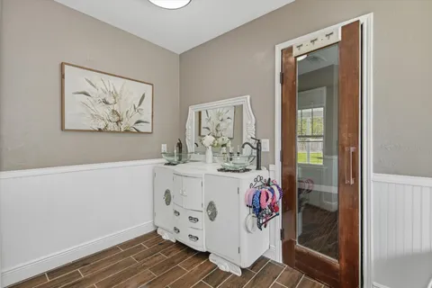 a bathroom with a sink mirror and vanity