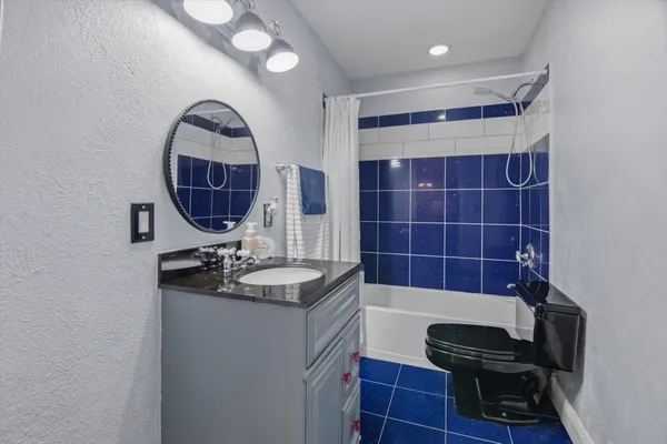 a bathroom with a sink a toilet and a mirror