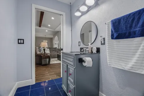 a bathroom with a sink mirror and tub
