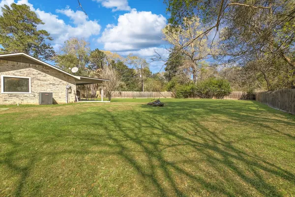 a backyard of a house with table and chairs