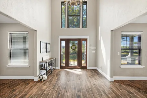 a view of a livingroom with wooden floor and a window