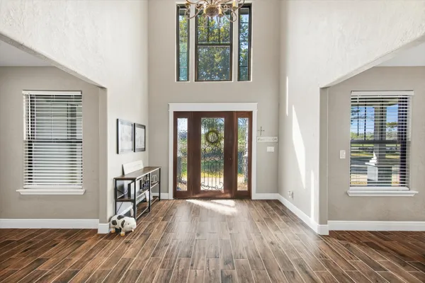 a view of a livingroom with wooden floor and a window