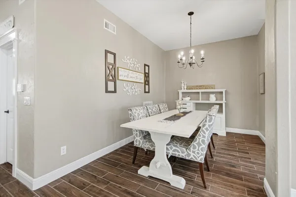 a view of a dining room with furniture and chandelier