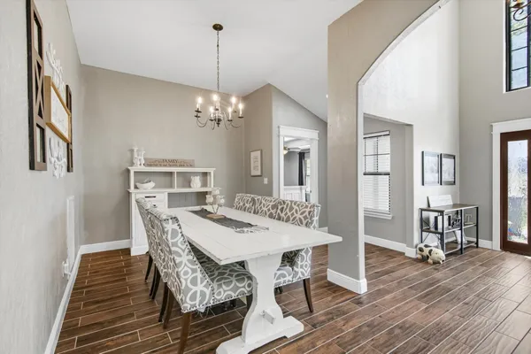 a view of a dining room with furniture and wooden floor