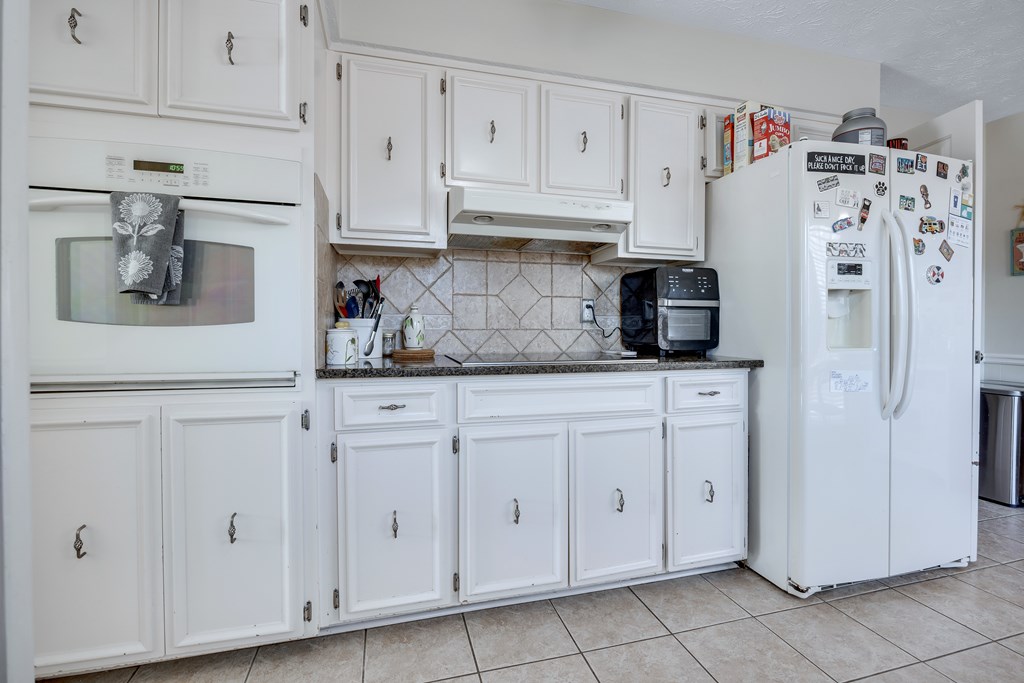 2 Biltmore Court Columbus, GA 31909 - Photo 11 of 29 a kitchen with white cabinets and refrigerator