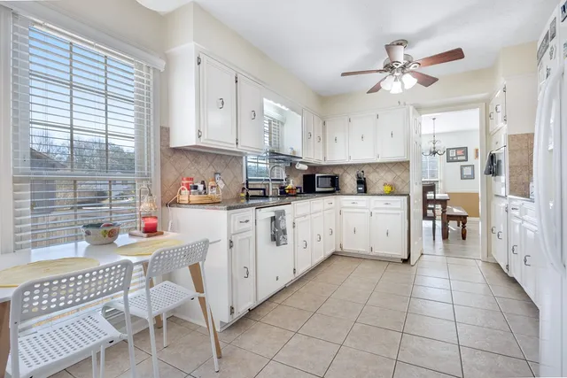 a kitchen with stainless steel appliances cabinets a sink and a window