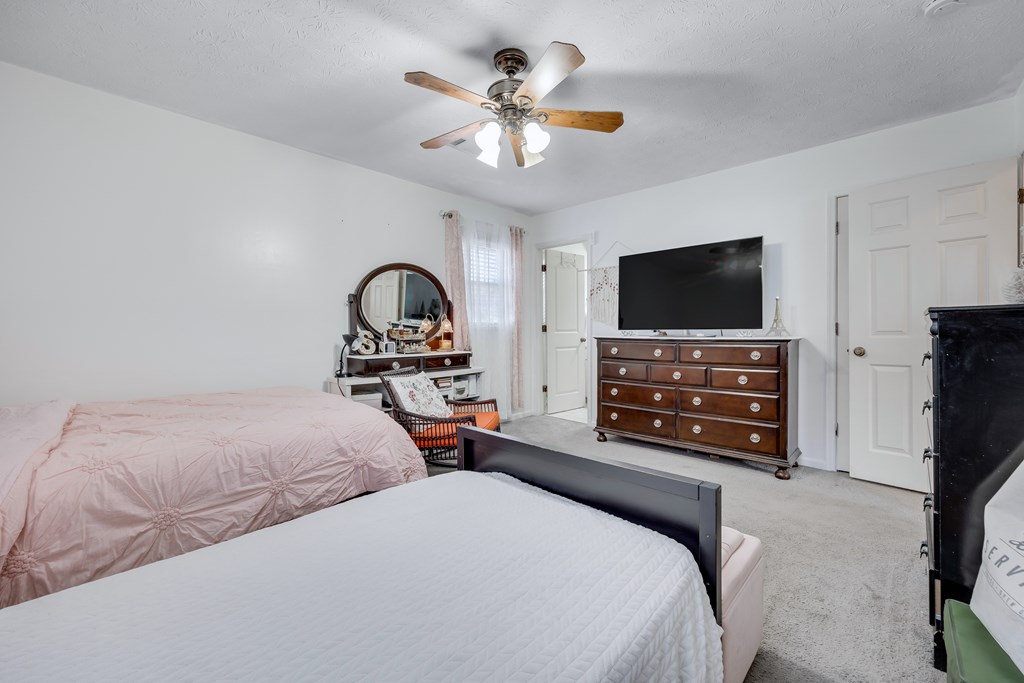 2 Biltmore Court Columbus, GA 31909 - Photo 19 of 29 a bedroom with bed and a flat tv screen on dresser