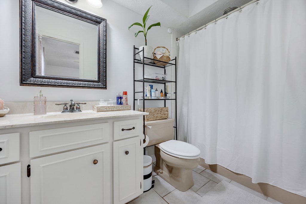 2 Biltmore Court Columbus, GA 31909 - Photo 20 of 29 a bathroom with a toilet a sink and a mirror