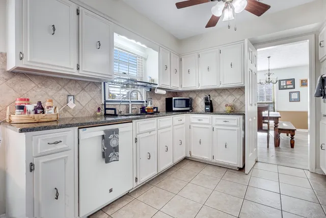 a kitchen with cabinets and window