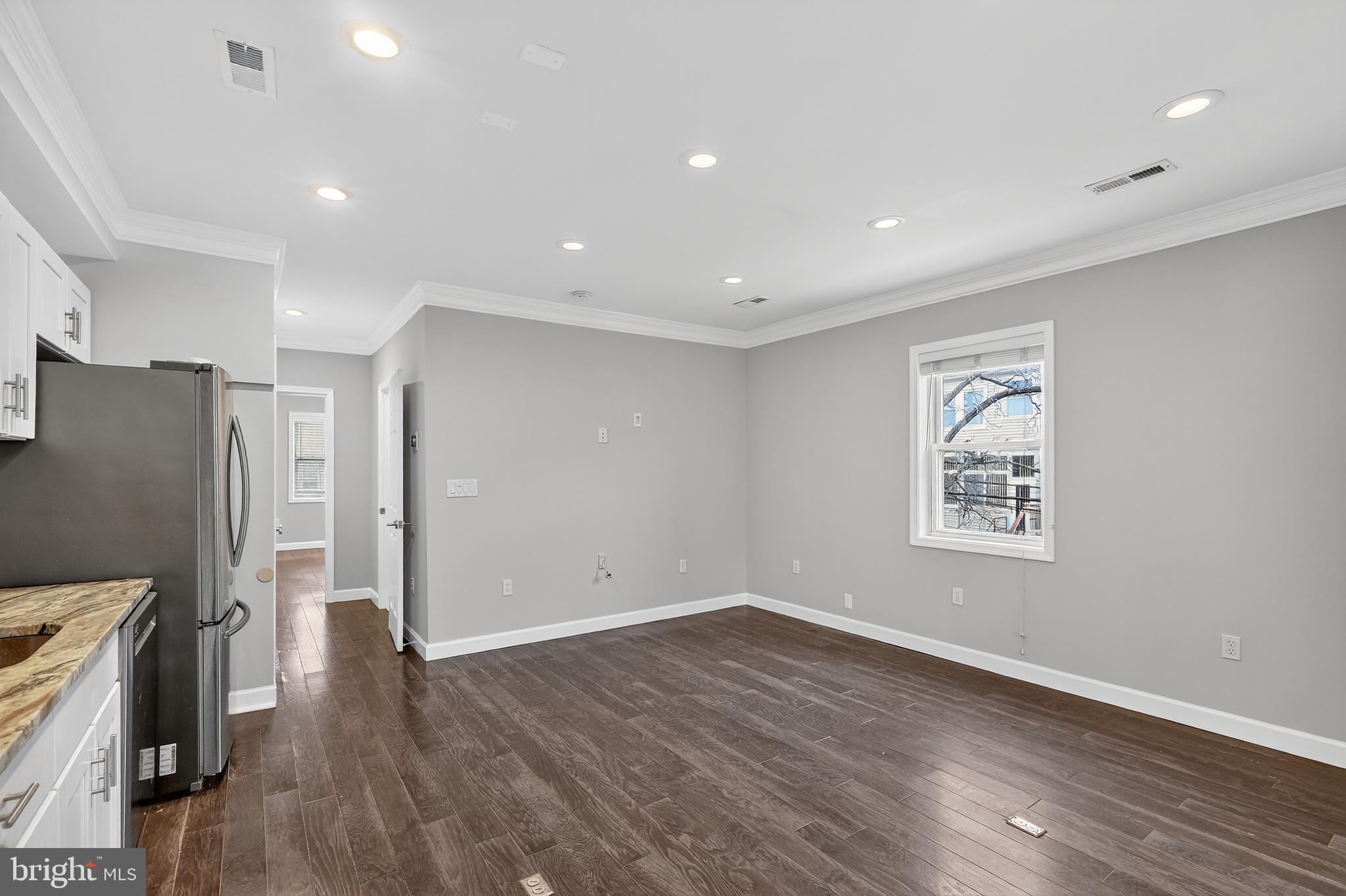 5619 1st Place Northwest, Unit 4 Washington, DC 20011 - Photo 12 of 24 an empty room with wooden floor and a window
